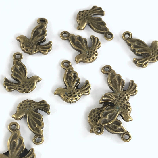 12 bronze jewelry charms that look like birds