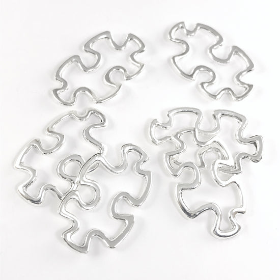 silver jewelry pendants shaped like puzzle pieces