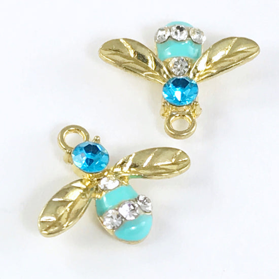 blue and gold jewelry charms that look like bees