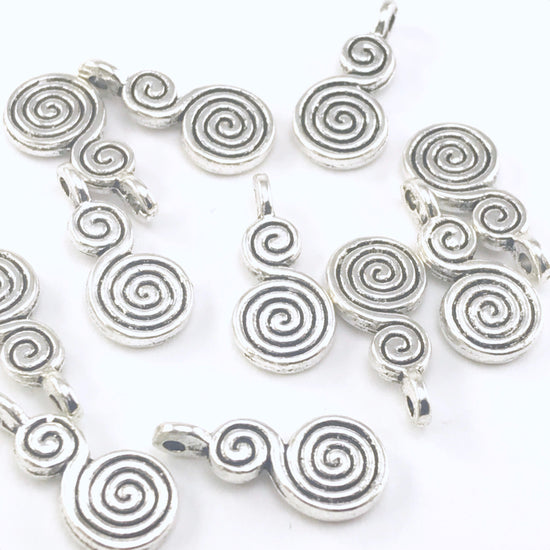 10 silver colour jewelry charms that are a whirl design