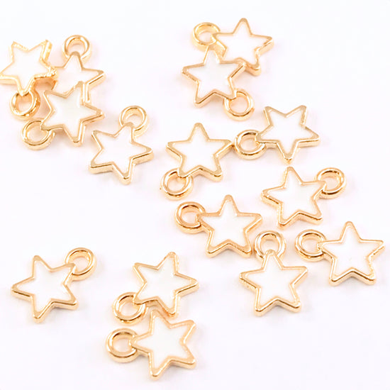 15 white and gold star shaped charms