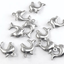 silver colour jewelry charms that look like dolphins