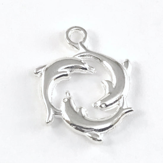 silver jewerly charm of 3 dolphins in a circle