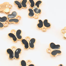 black and gold colour charms that are shaped like butterflies
