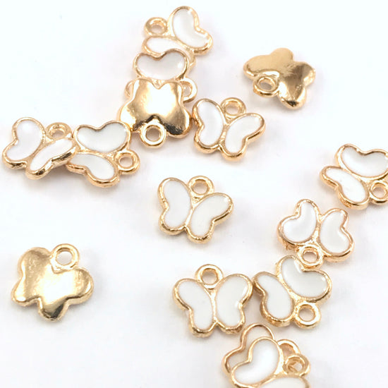 white and gold butterfly shaped charms