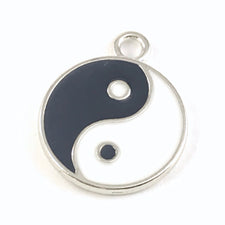 black white and silver jewerly charm that has yin yang symbol 