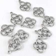 silver colour jewerly charms shaped like celtic knots