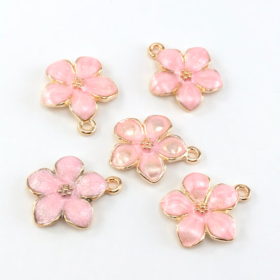 5 jewelry charms that look like pink and gold flowers