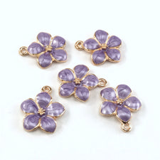 5 jewelry charms that look like purple and gold flowers
