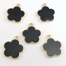 black and gold jewerly charms shaped like flowers