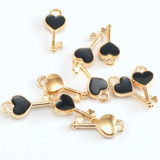 10 key shaped jewelry charms that are gold and black colour