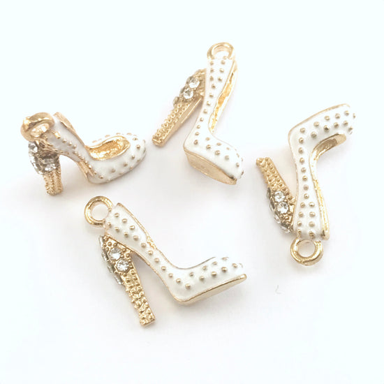 4 white and gold colour jewelry charms that look like shoes