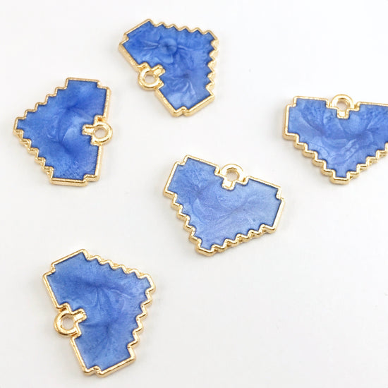 blue and gold jewerly pendants that are heart shaped