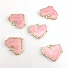 pink and gold jewelry pendants that are heart shaped
