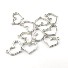 silver colour jewerlry charms shaped like a heart