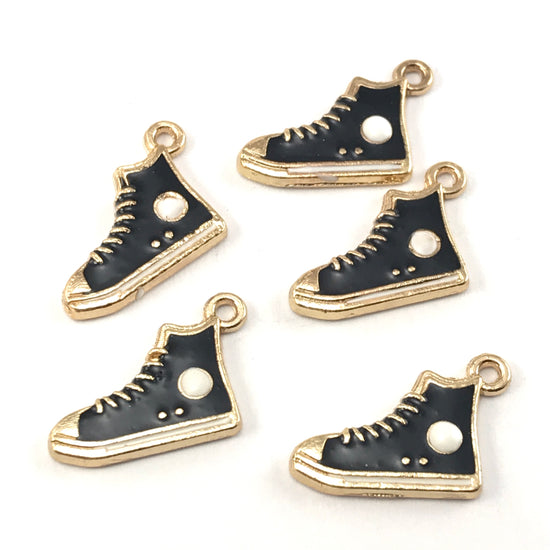 Black and gold colour jewelry charms that look like high top running shoes
