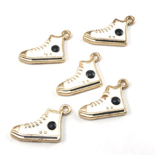 white and gold colour jewelry charms that look like high top running shoes