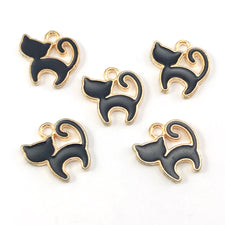 5 black and  gold colour jewerly charms that look like cats