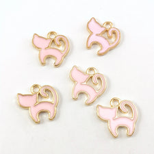 pink and gold colour jewerly charms that look like cats