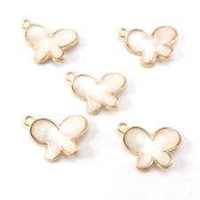white and gold colour jewerly charms shaped like butterflies