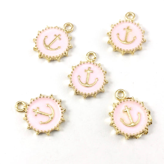 pink and gold jewelry charms that look like anchors