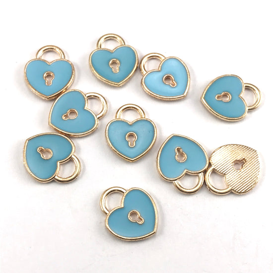 blue and gold jewerly charms that are heart shaped with a key hole