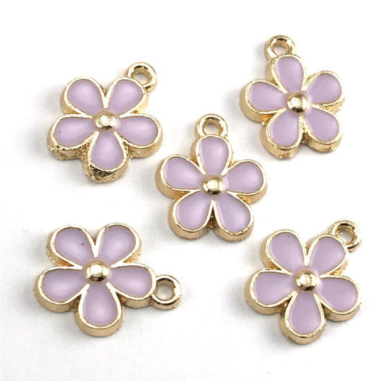 purple and gold colour jewerly charms that look like flowers