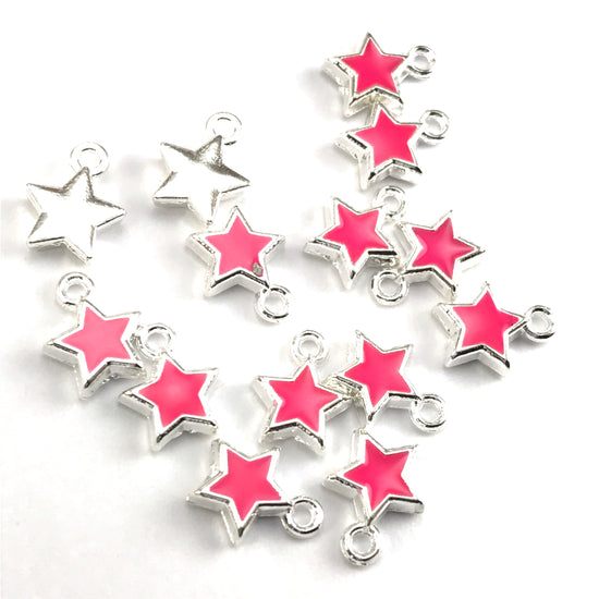 pink and silver jewerly charms shaped like stars
