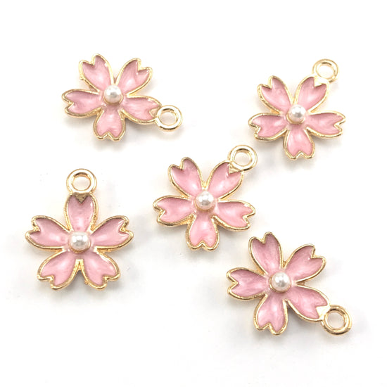 pink and gold colour jewerly charms that look like flowers