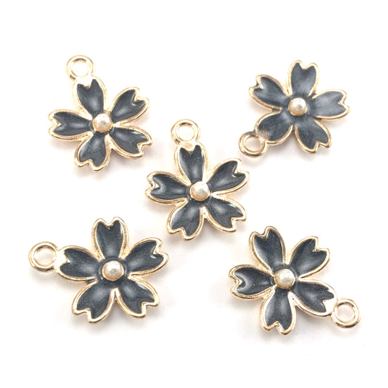 black and gold colour jewerly charms in the shape of flowers