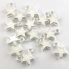 white and silver jewerly charms shaped like stars