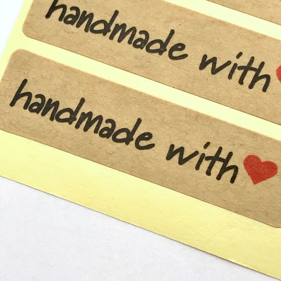 close up of craft paper sticker with handmade with heart on it