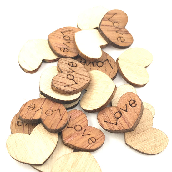 heart shaped wood pieces with the word love engraved on them