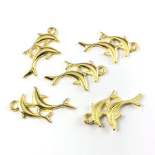 double dolphin shaped jewerly charms that are gold in colour