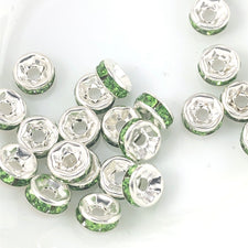 silver rondelle shaped beads with green rhinestones