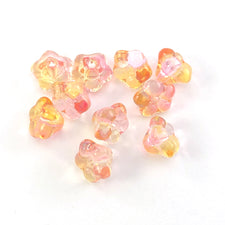 flower shaped beads that are clear with yellow and pink accent colours