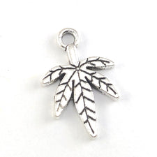 silver colour jewerly charm shaped like a leaf