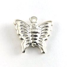 silver colour charm shaped like a butterfly