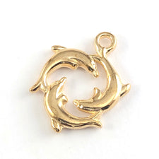 gold colour jewerlry charm that looks like 3 dolphins in a circle