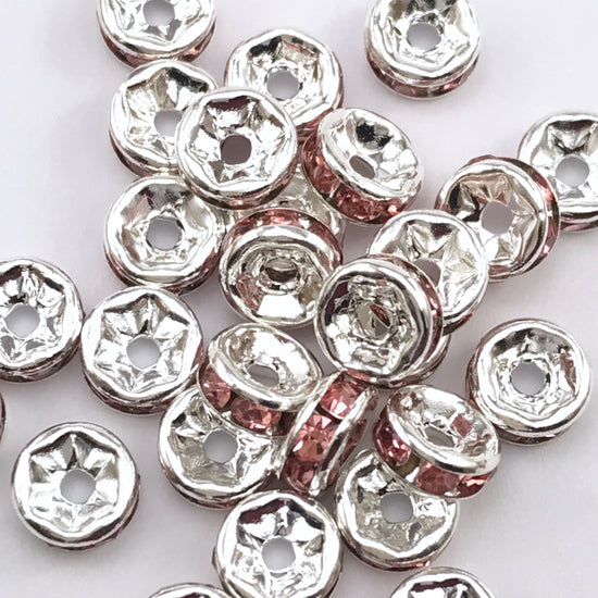 pile of silver and pink color rondelle jewelry beads