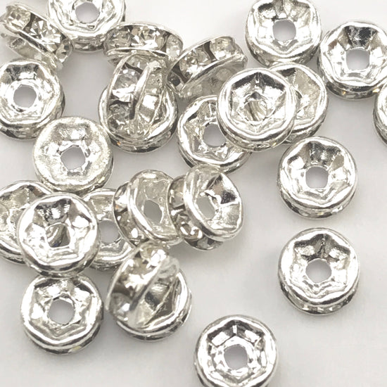 pile of silver and clear color rondelle jewelry beads
