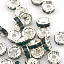 pile of silver and green color rondelle jewelry beads