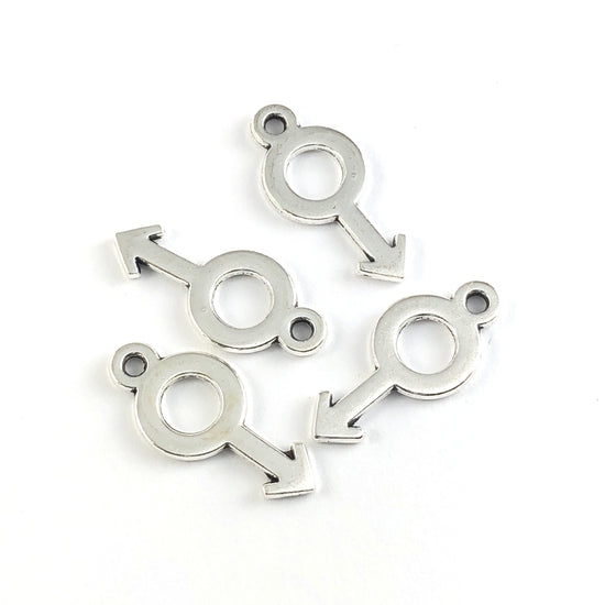 silver jewerly charms in the shape of the male gender symbol