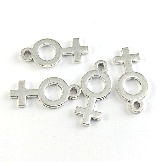 silver jewerly charms in the shape of the female gender symbol