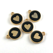 Five gold and black round jewerly charms, with a heart on them