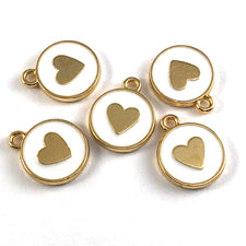 Five gold and white round jewerly charms, with a heart on them