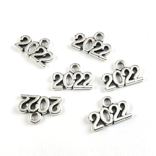silver jewerly charms in the shape of 2022