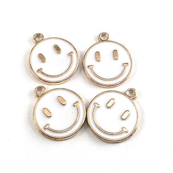 white and gold colour round jewelry charms that look like smiley faces