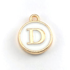 Round white and gold jewerly charm of the letter D