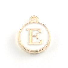 Round white and gold jewerly charm with the letter E on it